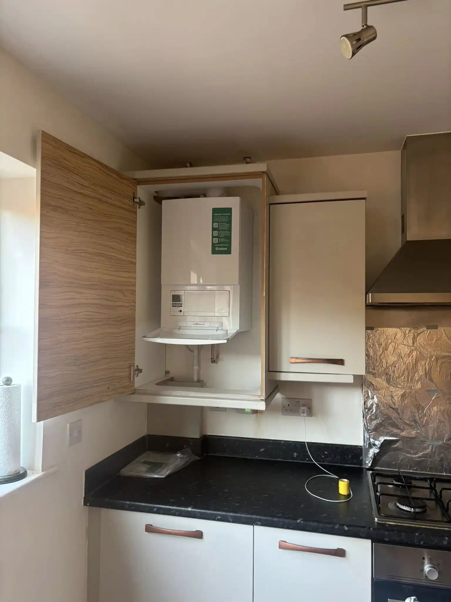 Vaillant boiler installed inside a kitchen wall cabinet.