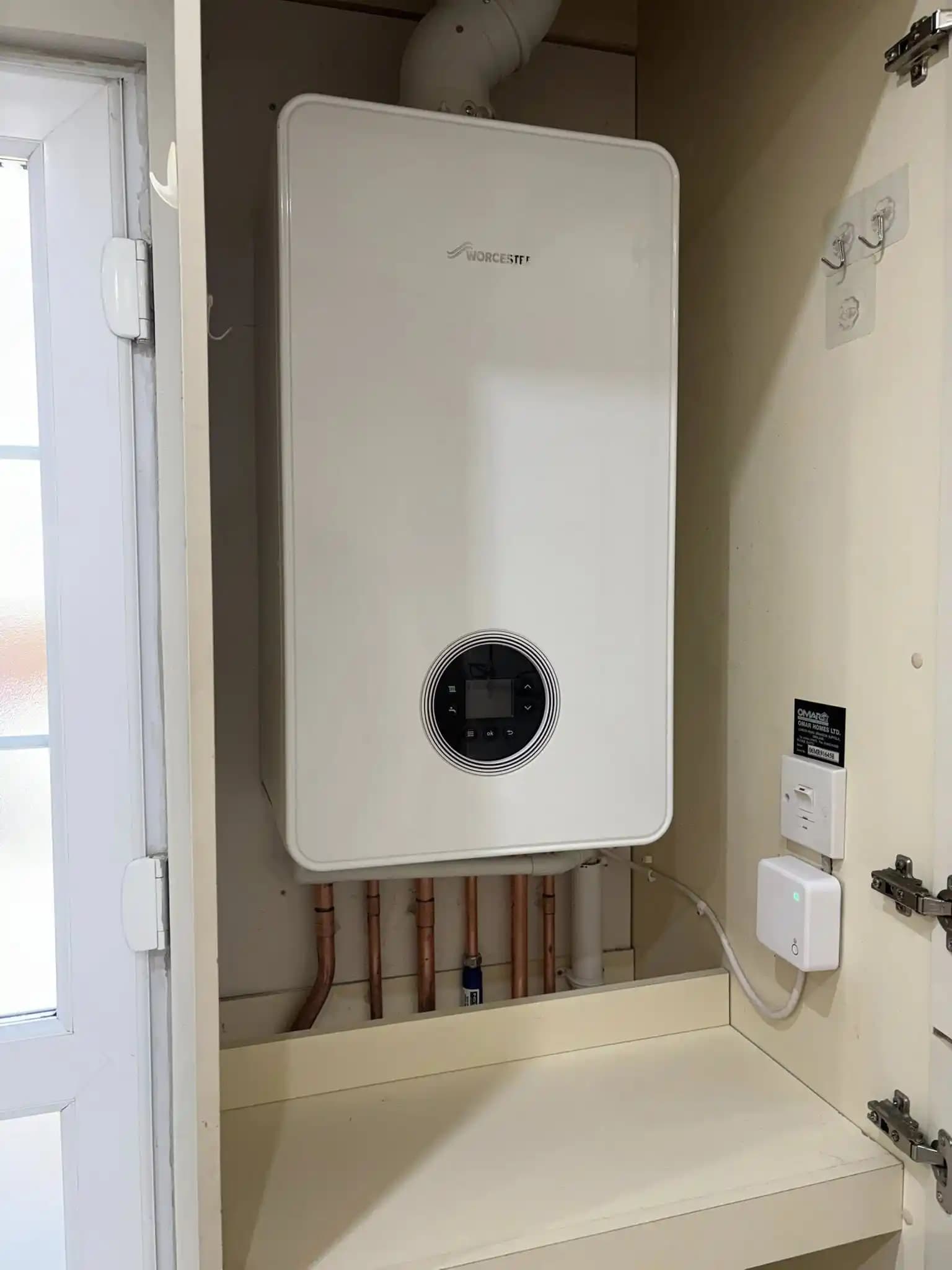 Worcester boiler installed neatly inside a cupboard above a shelf.