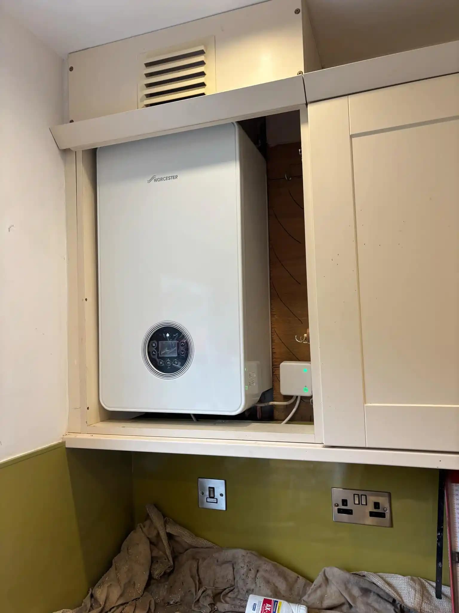 Worcester boiler installed neatly inside a kitchen cabinet.