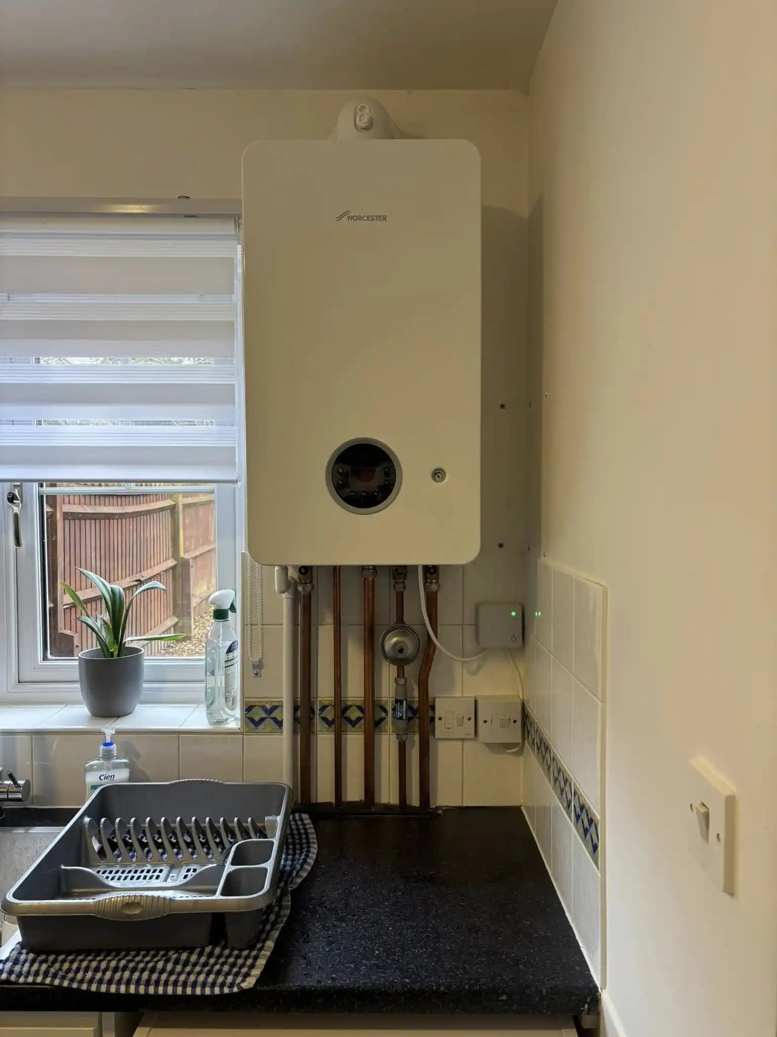 Worcester boiler installed in a kitchen with neat exposed copper pipework.